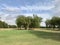 A beautiful golf ground, grass land, trees, cloud and blue sky