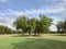 A beautiful golf ground, grass land, trees, cloud and blue sky