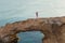 Beautiful gorgeous bride and stylish groom on rocks, on the background of a sea, wedding ceremony on cyprus