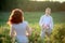 Beautiful gorgeous bride and stylish handsome groom, rustic couple in a rose field