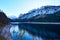 Beautiful Gosausee lake landscape with Dachstein mountains, forest, clouds and reflections in the water in Austrian Alps