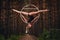 Beautiful and graceful aerial gymnast performs exercises on the air ring