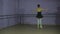 Beautiful graceful ballerine in black practice arabesque ballet position in hall