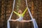 Beautiful and graceful trapeze artist performs exercises on aerial silk