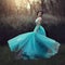 A beautiful graduate girl is spinning in a blue dress. Elegant young woman in a beautiful dress in the park. Art photo.
