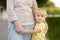 Beautiful granny and her little grandchild walking together in park