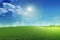 Beautiful grassy field nature landscape background with blooming glade, trees, hills and blue sky on a wonderful sunny day,