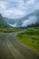 A beautiful gravel road leading into a valley of Rosendal in Folgefonna National park, Norway. Landscape of a overcast autumn day.