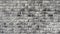 Beautiful gray brick wall, appears of focus and zooming. Hand made black and white brick wall, loft.