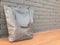 Beautiful gray eco tote bag on wooden table with gray brick wall. Simple design of tote bag without pattern, made from special