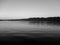 Beautiful grayscale shot of a lake in the evening