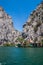 Beautiful green canyon of the river Cetina with rocks, stones and reflection in a water, summer landscape, Omis