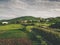 beautiful green fields road and hills near village