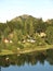 Beautiful green forest with little houses beside l