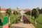 A beautiful green garden and the water fountain with no person visible.