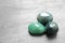 Beautiful green gemstones on grey table