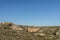 Beautiful green grass valley meadow with rock mountain in daylight summer with blue sky, Matera south Italy