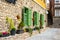 Beautiful green jalousie windows of renovated old building with stone walls