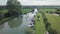 Beautiful Green Landscape And Tourists Kayaking Along Thames River In Southern England - aerial sho