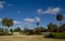 Beautiful green parklands with palm trees against clouds blue sky at the centennial park, Sydney, Australia.