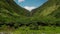 Beautiful green tropical canyon gorge with palms and waterfall on the end, flying toward, Kohala forest, Hawaii