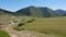 Beautiful green valley, road and mountains, panoramic view