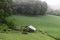 Beautiful greenery and field with a small chicken barn located at a farm in a small town