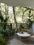 A beautiful greenery outdoor home balcony relaxation area with tropical plants