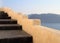 Beautiful grey and yellow unique steps and Aegean sea in Oia, Sa