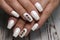 Beautiful groomed woman& x27;s hands, nails on the light gray background