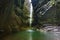 Beautiful grotto with pouring beautiful waterfall