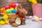 Beautiful group Easter eggs and Chocolate rabbit in the spring of easter day, red eggs, blue, purple and yellow in Wooden basket