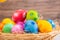 Beautiful group Easter eggs in the spring of easter day, red eggs, blue, purple and yellow in Wooden basket on the table