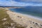 Beautiful Gurteen bay beach and blue color ocean water, cloudy sky. Stunning Irish nature scene in county Galway, Ireland. Warm