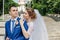 Beautiful guy and girl, bride in a white wedding dress, groom in a classic blue suit against a nature background. Wedding, family