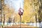 Beautiful gymnast do tricks on a portable platform in a beautiful autumn park. woman dance on a portable pole stage