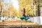 Beautiful gymnast do tricks on a portable platform in a beautiful autumn park. woman dance on a portable pole stage