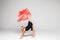 Beautiful gymnastics dancer on aerial silk in studio on white background.