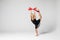 Beautiful gymnastics dancer on aerial silk in studio on white background.