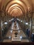 A beautiful hall-corridor with small windows of the proliferating ceiling arches.