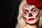 Beautiful Halloween Make-Up Style. Blond Model Wear Sugar Skull Makeup with Red Roses. Santa Muerte concept