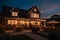 Beautiful Hampton Style Luxury House Home Building with Lamp Light at Night