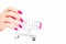 Beautiful hand slender fingers pink nail and shopping cart