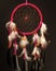 Beautiful handmade dreamcatcher hanging in front of a black background