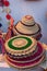 Beautiful handmade hats and doormats made by jute is displayed in a shop for sale in blurred background. Indian handicraft