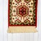 Beautiful handwoven carpet isolated against wooden background