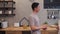 Beautiful happy asian couple are dancing in the kitchen at home. Young asian couple have romantic time while listening music.