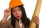 Beautiful and happy Asian Korean woman in hardhat holding building blueprints as architect engineer or constructor supervisor in