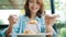 Beautiful happy Asian woman eating a plate of Italian seafood spaghetti at restaurant or cafe while smiling and looking at food