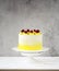 Beautiful happy birthday cake with mascarpone decorated with raspberry, pistachio